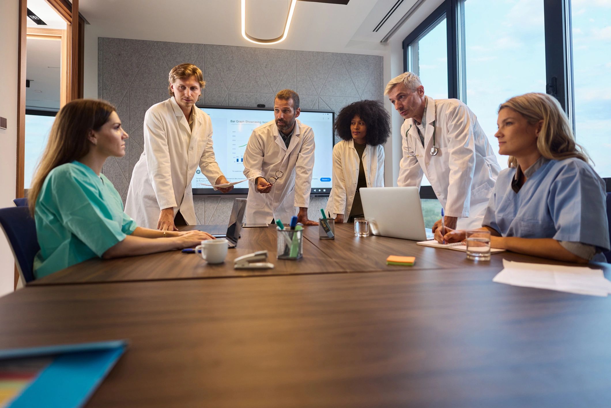 Healthcare leadership team meeting in a modern office