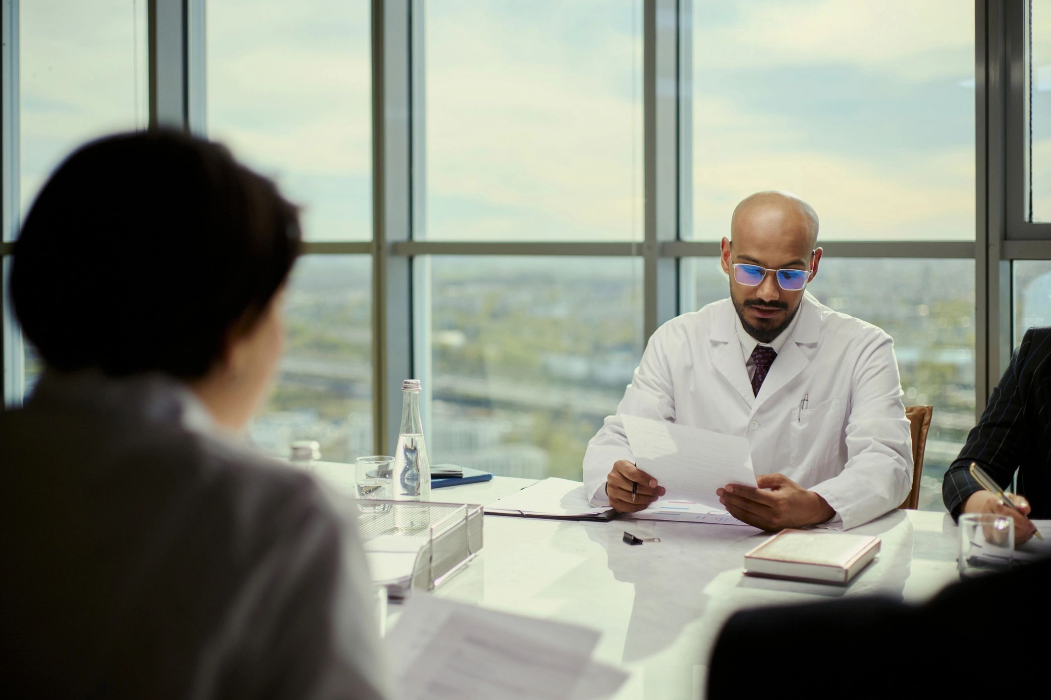 Doctor reviewing quality and compliance documents with colleagues