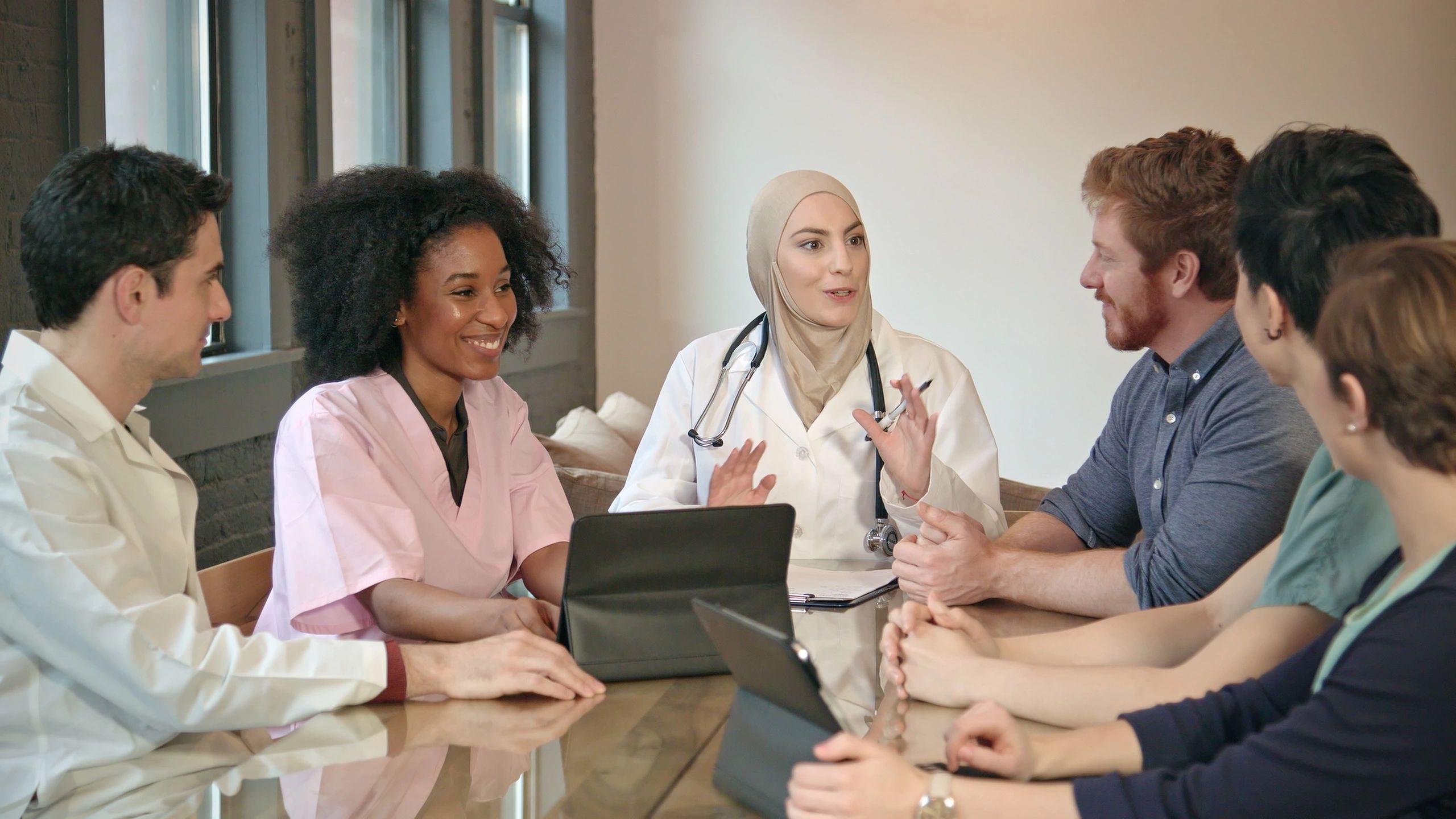 Healthcare leadership team meeting in an executive office